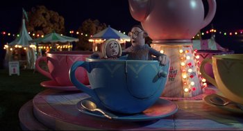 Movie still from “Wallace & Gromit: The Curse of the Were-Rabbit” (2005), directed by Nick Park – A blue cup with two figurines inside of it sitting on top of a table; Wide shot, High angle