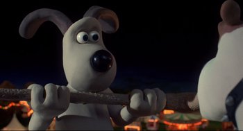 Movie still from “Wallace & Gromit: The Curse of the Were-Rabbit” (2005), directed by Nick Park – A dog holding a wooden stick; Close Up shot, Low angle