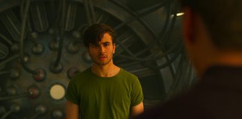 Movie still from “Another Life” (2019), created by Aaron Martin – A man in a green t - shirt stands in front of a mirror; Close Up shot, Over the shoulder angle