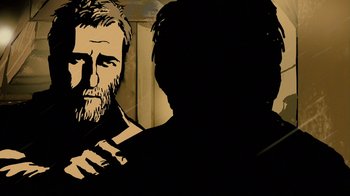 Movie still from “Waltz with Bashir” (2008), directed by Ari Folman – A black and white image of a man with a long beard; Close Up shot, Over the shoulder angle