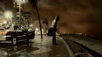 Movie still from “Waltz with Bashir” (2008), directed by Ari Folman – A man standing on the side of a road holding a surfboard; Extreme Wide shot, Low angle