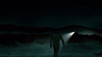 Movie still from “Waltz with Bashir” (2008), directed by Ari Folman – A man walking in the dark with a light shining on his head; Extreme Wide shot, Low angle