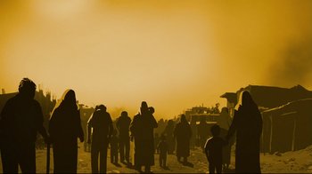 Movie still from “Waltz with Bashir” (2008), directed by Ari Folman – A group of people standing on top of a sandy beach; Extreme Wide shot, High angle