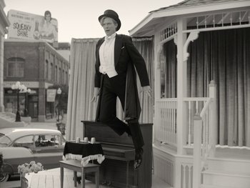 Movie still from “WandaVision” (2021), directed by Matt Shakman – A man standing on top of an old piano; Wide shot, Low angle