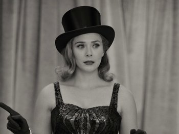 Movie still from “WandaVision” (2021), directed by Matt Shakman – A woman wearing a top hat in a black dress; Close Up shot, Low angle