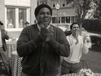 Movie still from “WandaVision” (2021), directed by Matt Shakman – Two men clapping at an outdoor event in the 1 9 5 0 s; Medium shot, Low angle