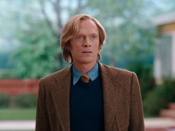 Movie still from “WandaVision” (2021), directed by Matt Shakman – A man with long blonde hair wearing a suit and tie; Medium shot, Low angle