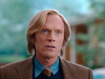 Movie still from “WandaVision” (2021), directed by Matt Shakman – A person wearing a suit and tie; Close Up shot, Low angle