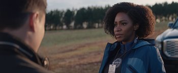 Movie still from “WandaVision” (2021), directed by Matt Shakman – A woman standing in front of a field with trees in the background; Close Up shot, Over the shoulder angle