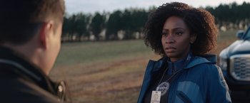 Movie still from “WandaVision” (2021), directed by Matt Shakman – A woman standing in front of a field with trees in the background; Close Up shot, Over the shoulder angle