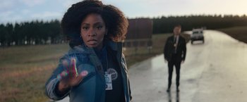 Movie still from “WandaVision” (2021), directed by Matt Shakman – A woman in a blue jacket and a man in a black jacket walking down a street; Close Up shot, Over the shoulder angle