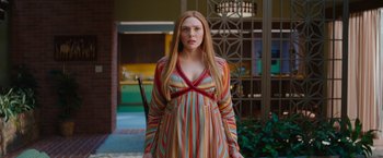 Movie still from “WandaVision” (2021), directed by Matt Shakman – A woman with long blonde hair wearing a colorful dress; Medium shot, Low angle
