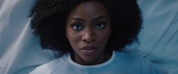 Movie still from “WandaVision” (2021), directed by Matt Shakman – A person's face in a white t - shirt; Close Up shot, Low angle