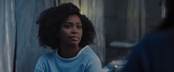Movie still from “WandaVision” (2021), directed by Matt Shakman – A black woman with curly hair sitting in a room; Close Up shot, Over the shoulder angle