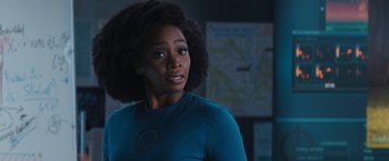 Movie still from “WandaVision” (2021), directed by Matt Shakman – A woman in a blue shirt is standing in front of a map; Close Up shot, Over the shoulder angle