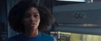 Movie still from “WandaVision” (2021), directed by Matt Shakman – A person wearing a blue t - shirt; Close Up shot, Over the shoulder angle