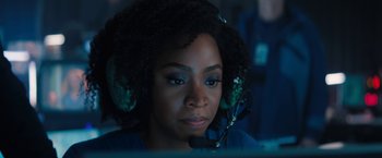 Movie still from “WandaVision” (2021), directed by Matt Shakman – A woman wearing a headset in front of a computer screen; Close Up shot, Over the shoulder angle