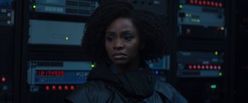 Movie still from “WandaVision” (2021), directed by Matt Shakman – A woman in a black jacket is looking at the camera; Close Up shot, Over the shoulder angle