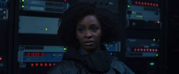 Movie still from “WandaVision” (2021), directed by Matt Shakman – A woman in a black jacket is looking at the camera; Close Up shot, Over the shoulder angle