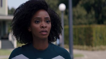 Movie still from “WandaVision” (2021), directed by Matt Shakman – A person wearing a shirt with trees in the background; Close Up shot, Over the shoulder angle