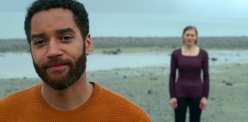 Movie still from “Another Life” (2019), created by Aaron Martin – A man and a woman standing on the beach; Close Up shot, Over the shoulder angle