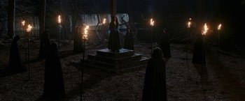 Movie still from “WandaVision” (2021), directed by Matt Shakman – A group of people standing around in the dark; Wide shot, High angle