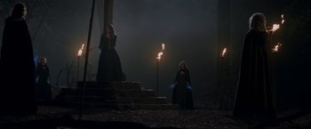 Movie still from “WandaVision” (2021), directed by Matt Shakman – Two women are standing next to a lit torch; Wide shot, Low angle