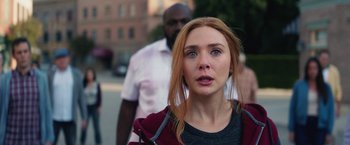 Movie still from “WandaVision” (2021), directed by Matt Shakman – A young woman with a surprised look on her face; Close Up shot, Over the shoulder angle