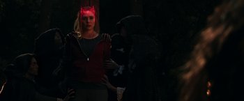 Movie still from “WandaVision” (2021), directed by Matt Shakman – A woman wearing a red devil's mask and holding a whip in the dark; Medium shot, Over the shoulder angle