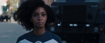 Movie still from “WandaVision” (2021), directed by Matt Shakman – A person wearing a blue and white t - shirt; Close Up shot, Over the shoulder angle