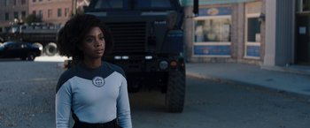 Movie still from “WandaVision” (2021), directed by Matt Shakman – A woman standing in front of an armored vehicle; Medium shot, Over the shoulder angle