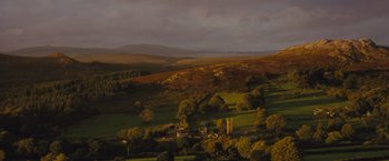 Movie still from “War Horse” (2011), directed by Steven Spielberg – A view of a green valley with trees and hills in the background; Extreme Wide shot, High angle
