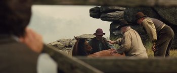 Movie still from “War Horse” (2011), directed by Steven Spielberg – Two men sitting next to a horse on a field; Wide shot, Over the shoulder angle