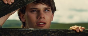 Movie still from “War Horse” (2011), directed by Steven Spielberg – A young man's face in a camouflage hat; Close Up shot, Low angle