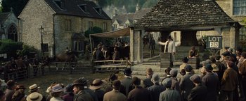 Movie still from “War Horse” (2011), directed by Steven Spielberg – A group of people standing in front of a building; Wide shot, High angle
