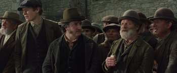 Movie still from “War Horse” (2011), directed by Steven Spielberg – A group of men standing next to each other; Medium shot, Low angle