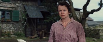 Movie still from “War Horse” (2011), directed by Steven Spielberg – A woman standing in front of a house; Close Up shot, Low angle