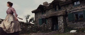 Movie still from “War Horse” (2011), directed by Steven Spielberg – An old stone house with a thatched roof; Extreme Wide shot, Low angle