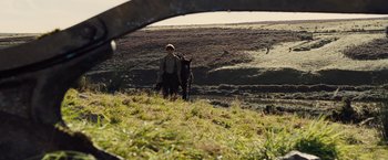 Movie still from “War Horse” (2011), directed by Steven Spielberg – A man and a dog walking in a field; Wide shot, Over the shoulder angle