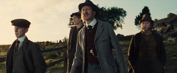 Movie still from “War Horse” (2011), directed by Steven Spielberg – A man in a suit and a man in a hat; Medium shot, Low angle