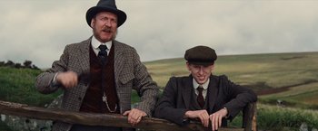 Movie still from “War Horse” (2011), directed by Steven Spielberg – A man and a boy leaning against a fence; Medium shot, Low angle