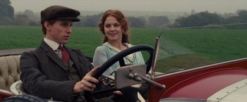 Movie still from “War Horse” (2011), directed by Steven Spielberg – A woman sitting in the driver's seat of an antique car; Close Up shot, Over the shoulder angle