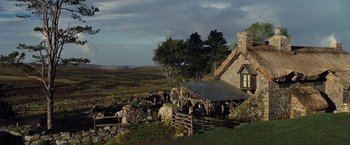 Movie still from “War Horse” (2011), directed by Steven Spielberg – An image of a house on the side of a hill; Extreme Wide shot, Low angle