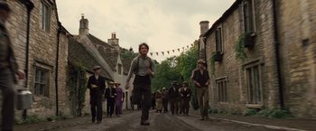 Movie still from “War Horse” (2011), directed by Steven Spielberg – A group of people walking down a street; Wide shot, Low angle