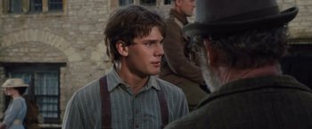 Movie still from “War Horse” (2011), directed by Steven Spielberg – A young man in a striped shirt is talking to an older man; Close Up shot, Over the shoulder angle