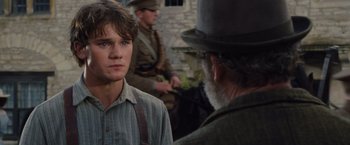 Movie still from “War Horse” (2011), directed by Steven Spielberg – A young man and an older man in a hat; Close Up shot, Over the shoulder angle