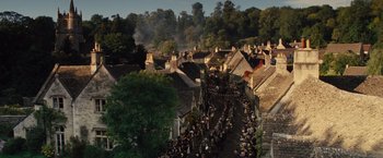 Movie still from “War Horse” (2011), directed by Steven Spielberg – A crowd of people walking down a street in a town; Extreme Wide shot, High angle
