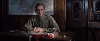 Movie still from “War Horse” (2011), directed by Steven Spielberg – A man sitting at a table in front of a map; Medium shot, Over the shoulder angle