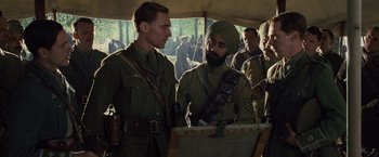 Movie still from “War Horse” (2011), directed by Steven Spielberg – A group of men standing next to each other in a field; Medium shot, Over the shoulder angle