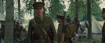 Movie still from “War Horse” (2011), directed by Steven Spielberg – A man in a military uniform with a rifle; Medium shot, Low angle